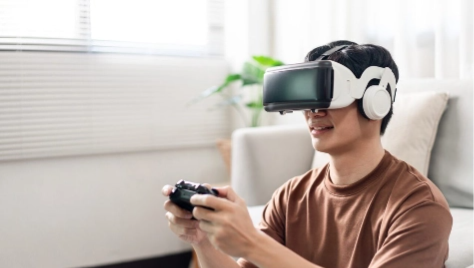 young man wearing a virtual reality headset young man wearing a virtual reality headset