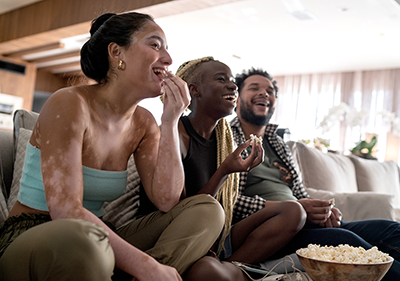 People watching TV on couch People watching TV on couch