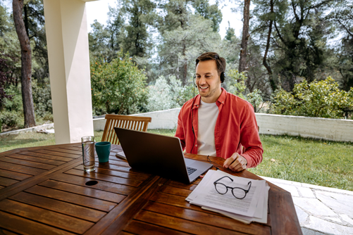 Guy working from home on his patio Guy working from home on his patio