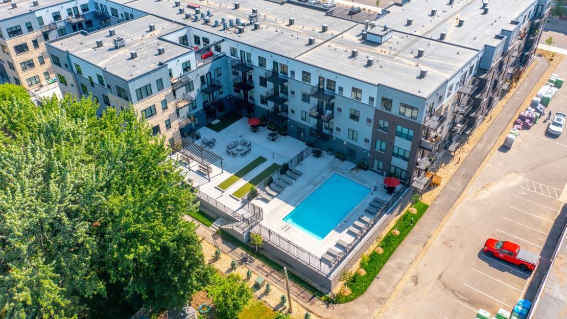 pool courtyard surrounded by apartment complex