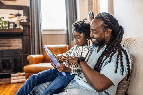 Father and son using a tablet and low latency internet