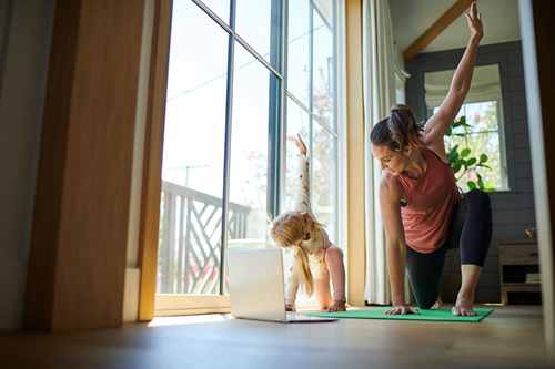 Mom and daughter doing online yoga Mom and daughter doing online yoga