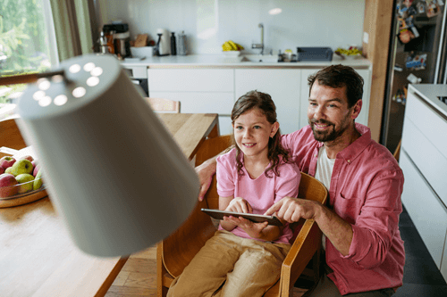 Dad and daughter using smart home device with low latency internet